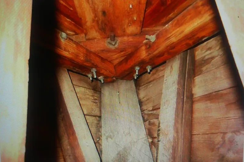 Slide: The Image of Interior view of 1955 Custom Gaff Rigged Ketch wooden structure and bolts. - 42