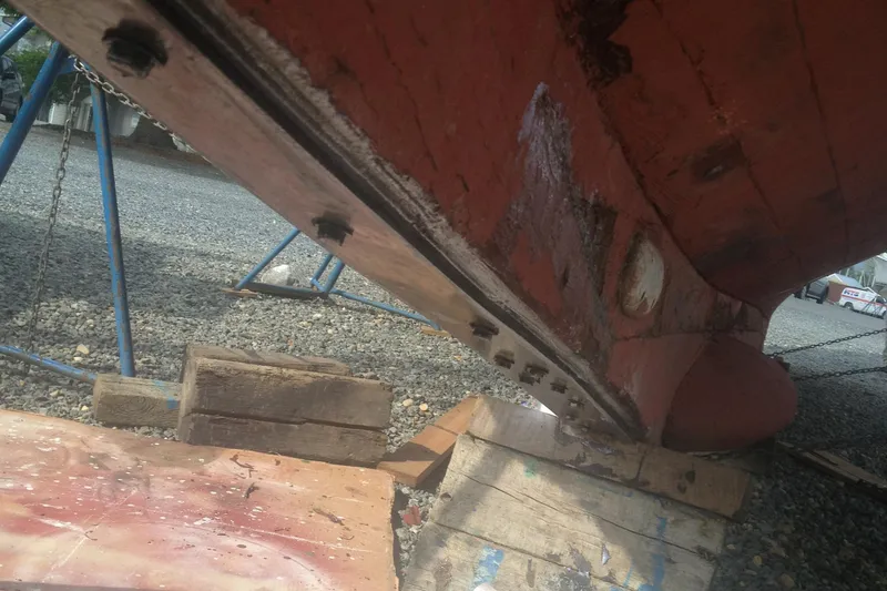 Slide: The Image of 1955 One Off custom-built full keel ketch under repair on wooden blocks. - 49