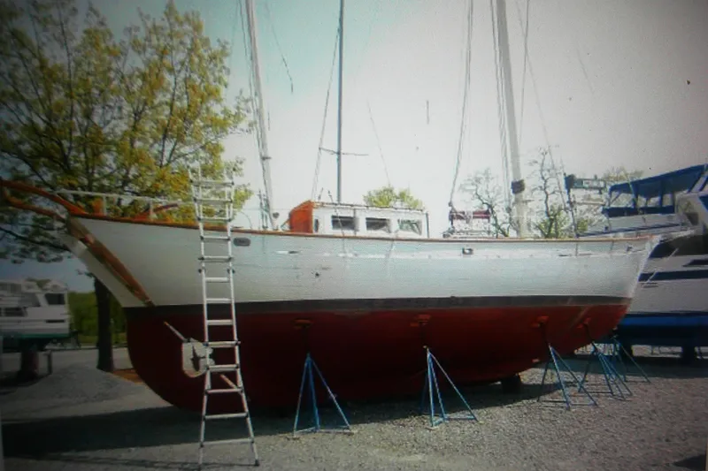 Slide: The Image of 1955 Custom Gaff Rigged Ketch on stands, full keel, ladder nearby. - 6
