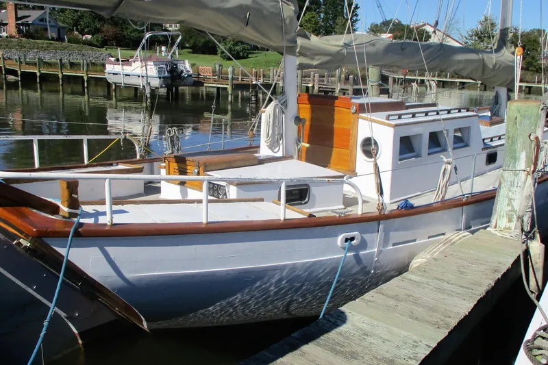 Slide: The Image of 1955 Custom Gaff Rigged Ketch docked, showcasing classic wooden design and full keel structure. - 8