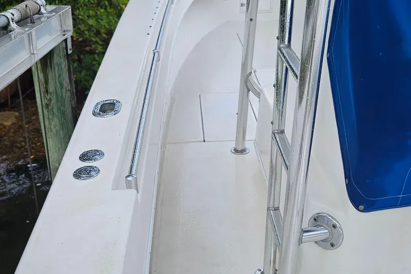 Slide: The Image of 2002 Contender 31 Open boat with blue cover and metal railing. - 12