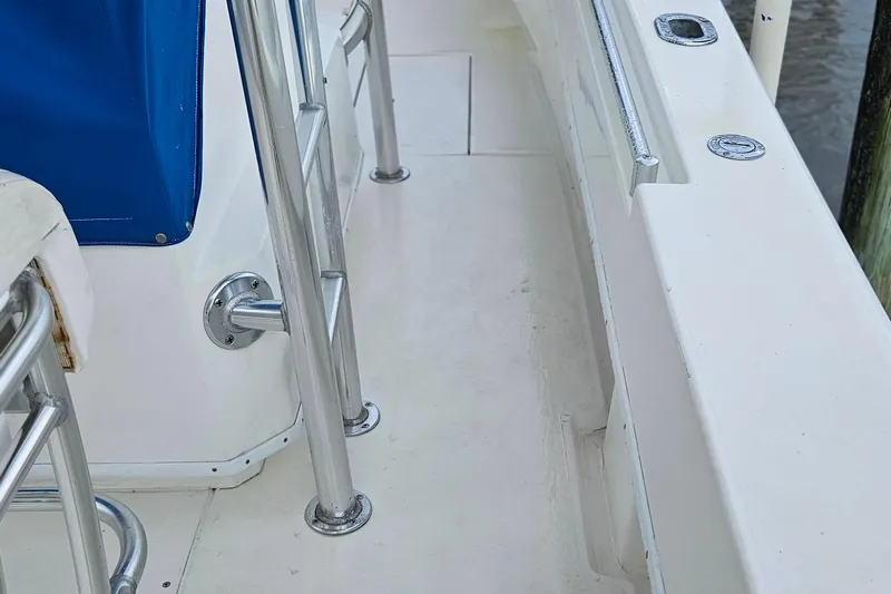 Slide: The Image of 2002 Contender 31 Open boat deck with chrome fittings and blue canvas detail. - 13