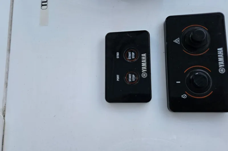 Slide: The Image of Throttle controls on a 2002 Contender 31 Open boat, featuring chrome and black design. - 19