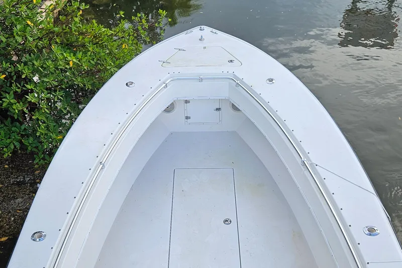 Slide: The Image of Steering wheel and controls of a 2002 Contender 31 Open boat. - 23
