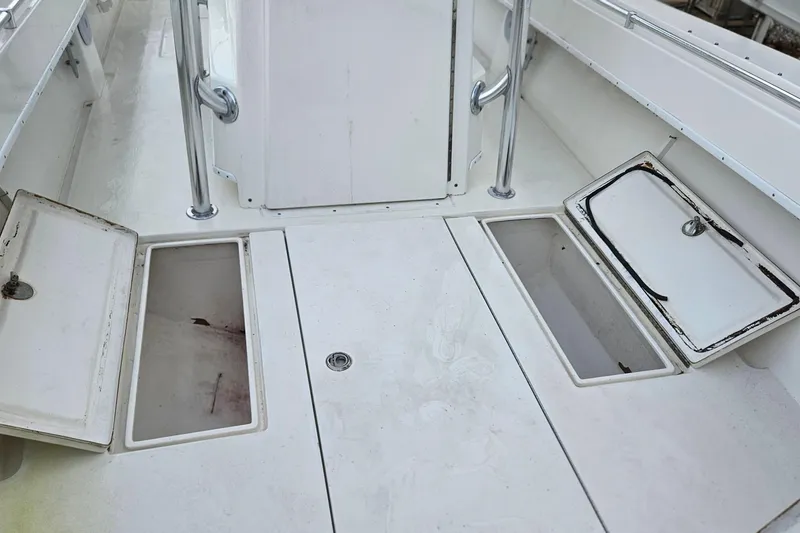 Slide: The Image of 2002 Contender 31 Open boat with dual outboard engines docked at a marina. - 25