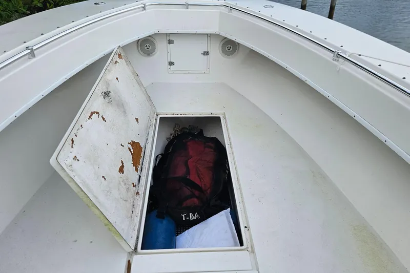 Slide: The Image of 2002 Contender 31 Open boat deck with open storage compartments. - 26