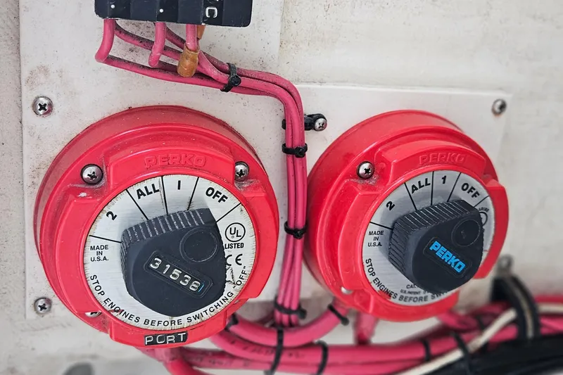 Slide: The Image of Three marine batteries in a 2002 Contender 31 Open boat compartment. - 34