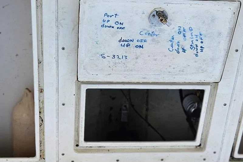 Slide: The Image of 2002 Contender 31 Open boat with open storage compartments and Yamaha engines. - 40