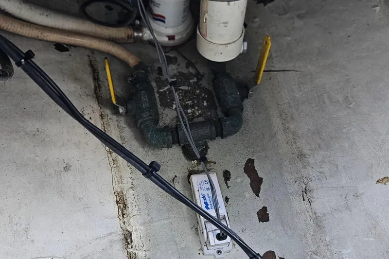 Slide: The Image of 2002 Contender 31 Open boat compartment with handwritten instructions on the hatch. - 41