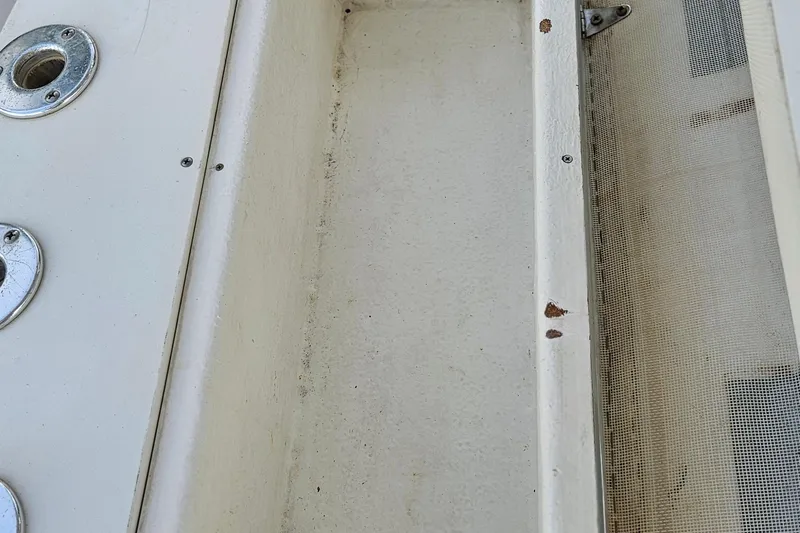 Slide: The Image of Close-up of a "Top Guns by Rupp" logo on a Contender 31 Open, 2002 model. - 46