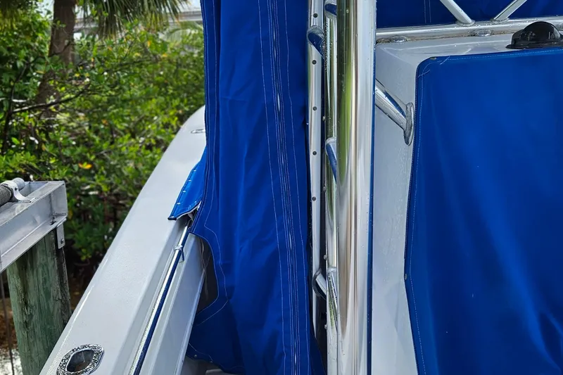 Slide: The Image of 2002 Contender 31 Open boat with blue canopy and metal framework. - 52