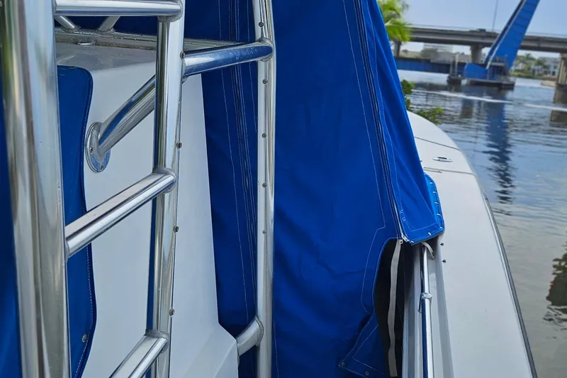 Slide: The Image of 2002 Contender 31 Open boat with blue canvas cover and stainless steel railing. - 53