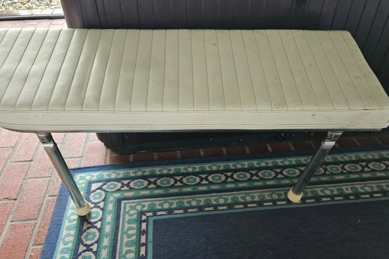 Slide: The Image of Two metal poles on a brick-patterned floor, near a wooden table. - 56