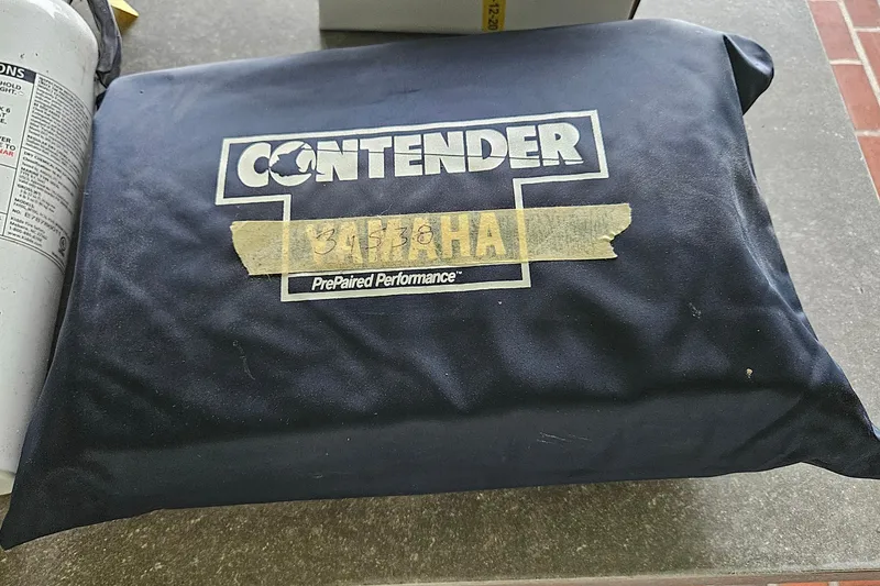 Slide: The Image of Padded bench seat from a 2002 Contender 31 Open boat, on a patterned rug. - 57