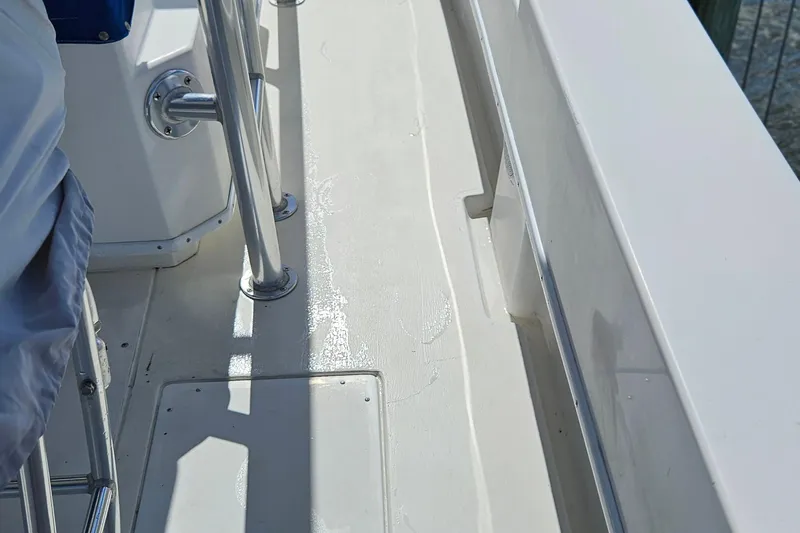 Slide: The Image of 2002 Contender 31 Open boat deck with stainless steel fittings and wet surface. - 6