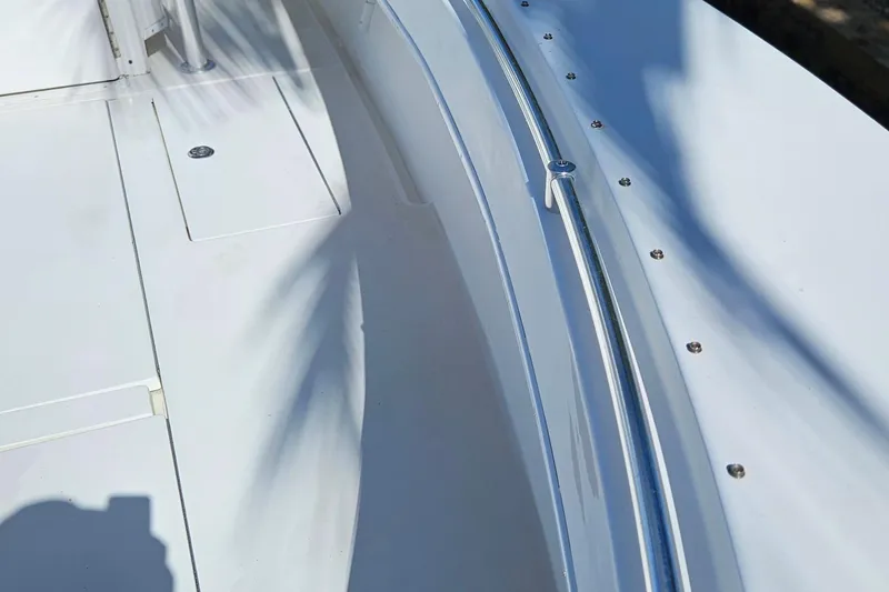 Slide: The Image of 2002 Contender 31 Open boat deck with stainless steel railings and storage compartments. - 9