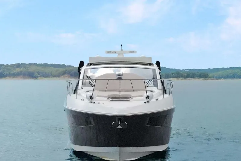 Slide: The Image of 2018 Cruisers Yachts 390 EC on calm water, front view with scenic background. - 17