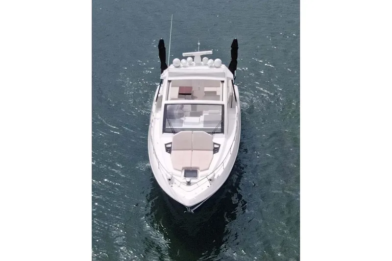 Slide: The Image of 2018 Cruisers Yachts 390 EC on water, aerial view showcasing sleek design. - 19