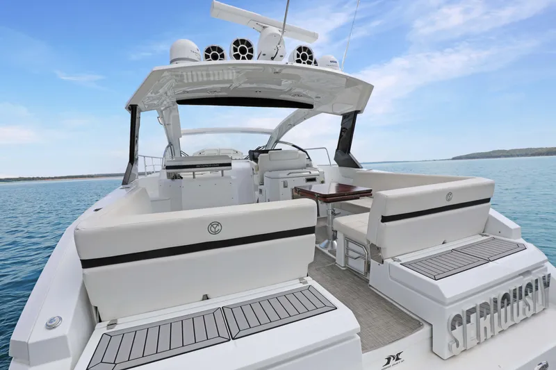 Slide: The Image of 2018 Cruisers Yachts 390 EC luxury boat with spacious seating and sleek design on open water. - 21