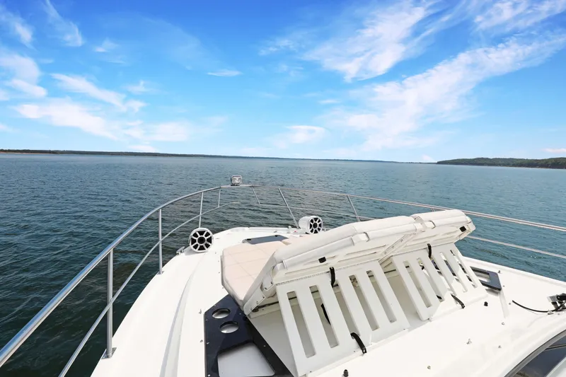 Slide: The Image of 2018 Cruisers Yachts 390 EC on open water under clear blue sky. - 33