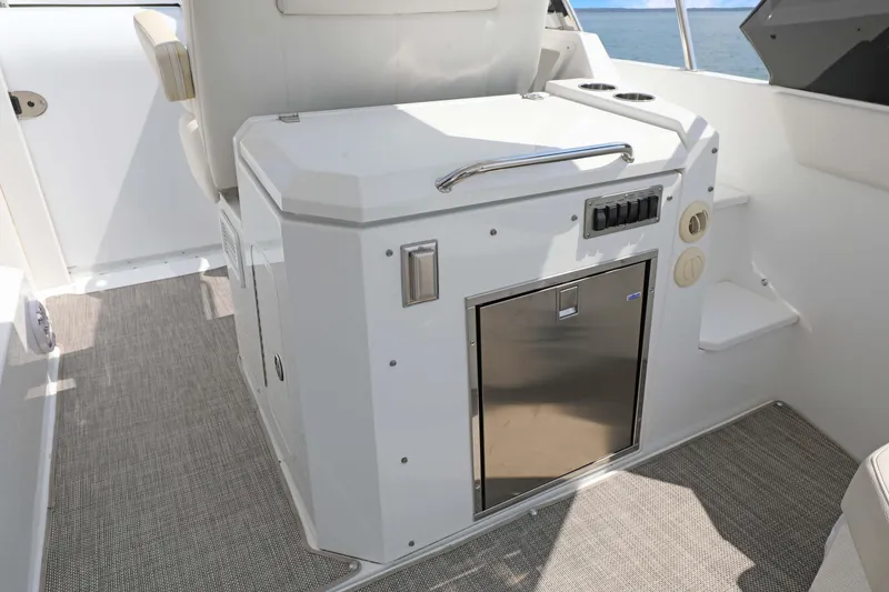 Slide: The Image of 2018 Cruisers Yachts 390 EC interior with compact kitchenette and ocean view. - 39