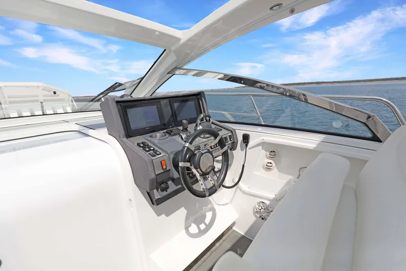 Slide: The Image of 2018 Cruisers Yachts 390 EC helm with modern controls and ocean view. - 46
