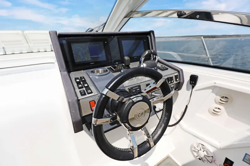 Slide: The Image of Helm of 2018 Cruisers Yachts 390 EC with modern controls and navigation screens. - 47