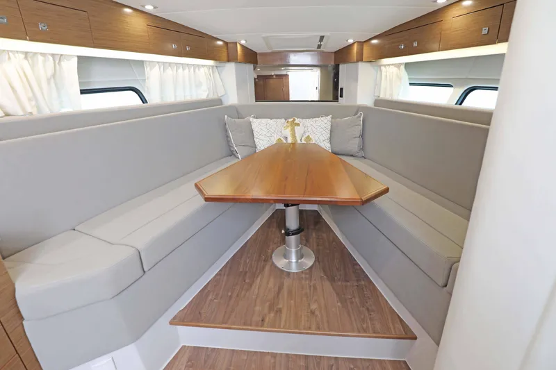 Slide: The Image of 2018 Cruisers Yachts 390 EC interior with elegant dining area and modern furnishings. - 52