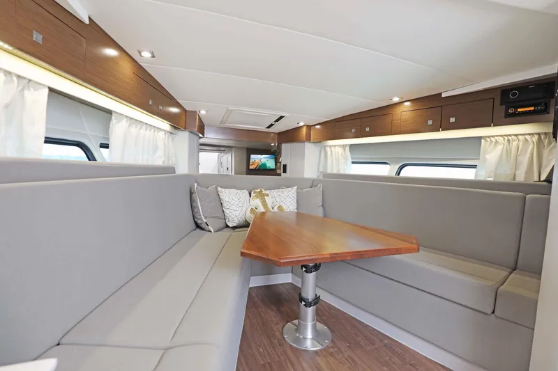 Slide: The Image of Luxurious interior of 2018 Cruisers Yachts 390 EC with elegant seating and wooden table. - 53