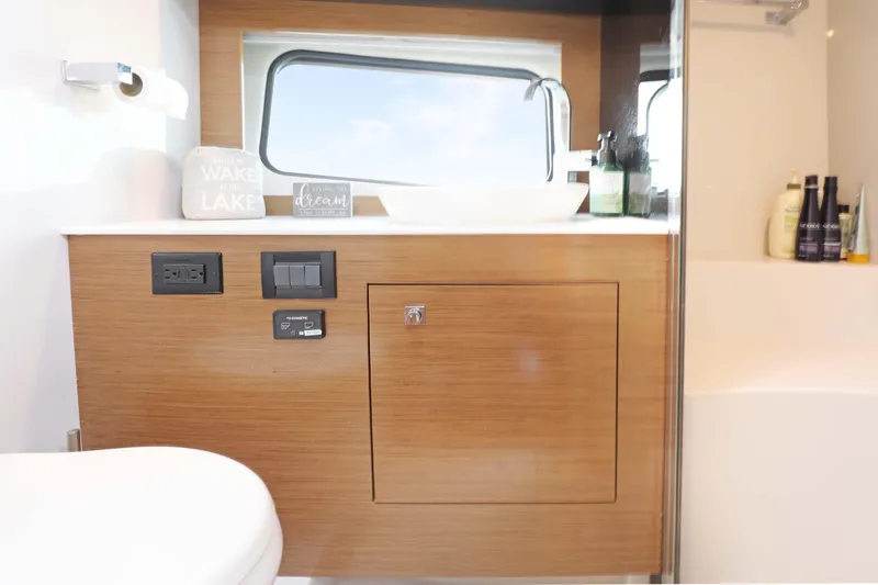 Slide: The Image of Luxurious bathroom interior of 2018 Cruisers Yachts 390 EC with modern fixtures and wood accents. - 61