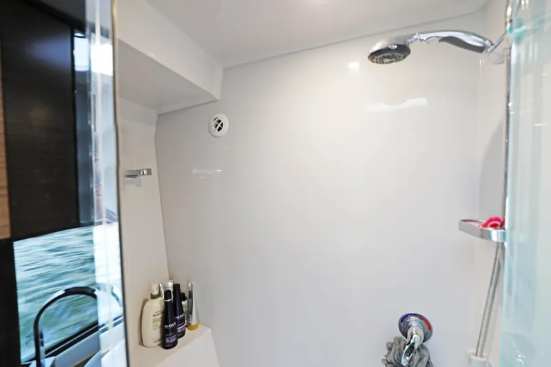Slide: The Image of Shower area in 2018 Cruisers Yachts 390 EC, featuring modern fixtures and toiletries. - 62