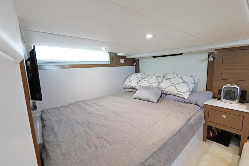 Slide: The Image of Luxurious bedroom interior of 2018 Cruisers Yachts 390 EC with modern decor and cozy bedding. - 64