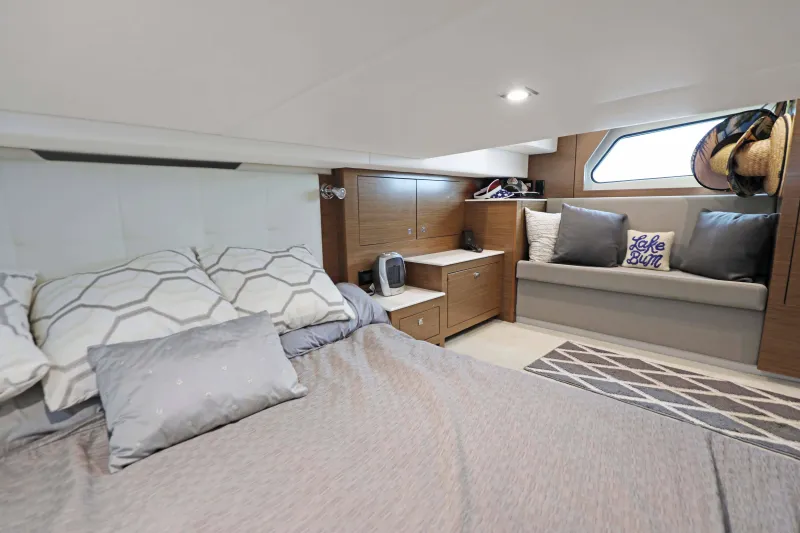 Slide: The Image of Luxurious 2018 Cruisers Yachts 390 EC cabin interior with cozy bed and seating area. - 67