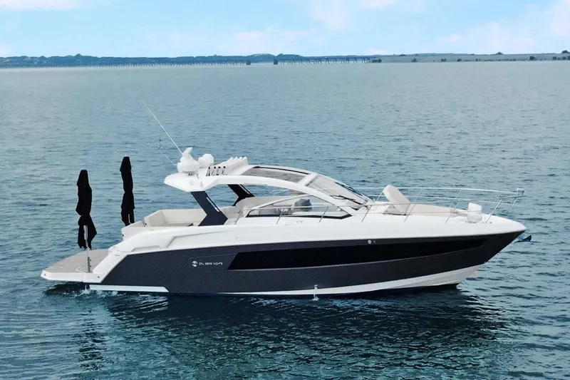 Slide: The Image of 2018 Cruisers Yachts 390 EC on calm water, showcasing sleek design and luxury features. - 9