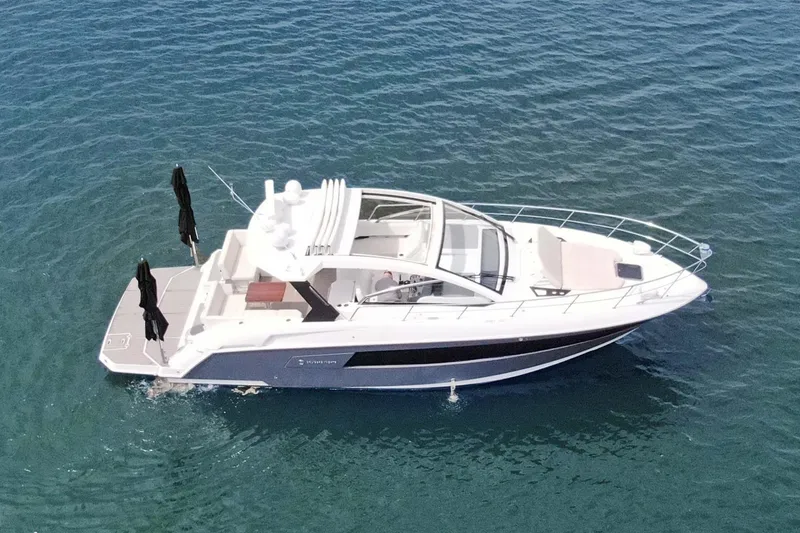 Slide: The Image of 2018 Cruisers Yachts 390 EC on calm blue water, aerial view. - 11