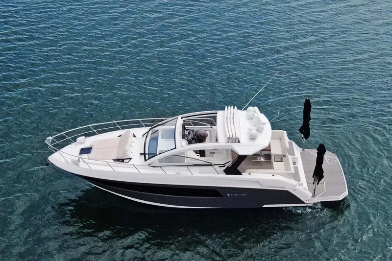 Slide: The Image of 2018 Cruisers Yachts 390 EC luxury boat on calm blue water. - 12