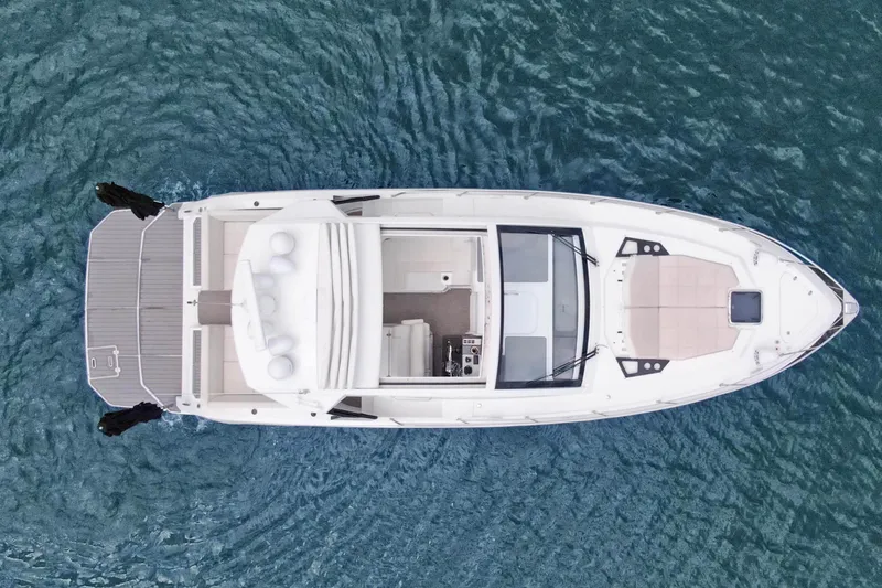 Slide: The Image of Aerial view of 2018 Cruisers Yachts 390 EC on blue water. - 15