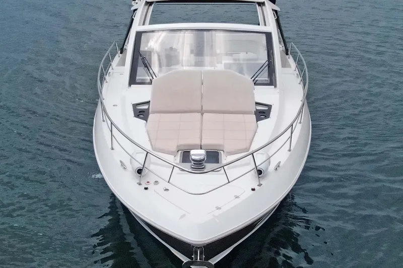 Slide: The Image of 2018 Cruisers Yachts 390 EC on water, showcasing sleek design and spacious deck. - 16
