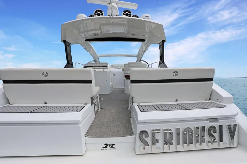 Slide: The Image of 2018 Cruisers Yachts 390 EC, luxury boat interior with "Seriously" signage, ocean backdrop. - 22
