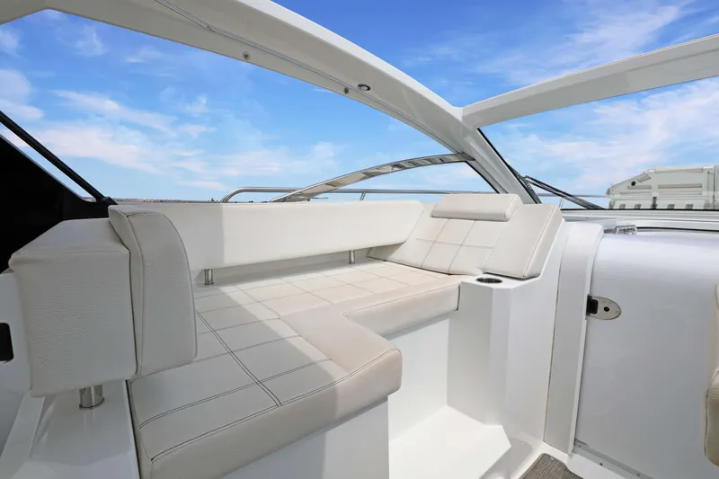 Slide: The Image of Luxurious seating area on 2018 Cruisers Yachts 390 EC under a clear blue sky. - 30