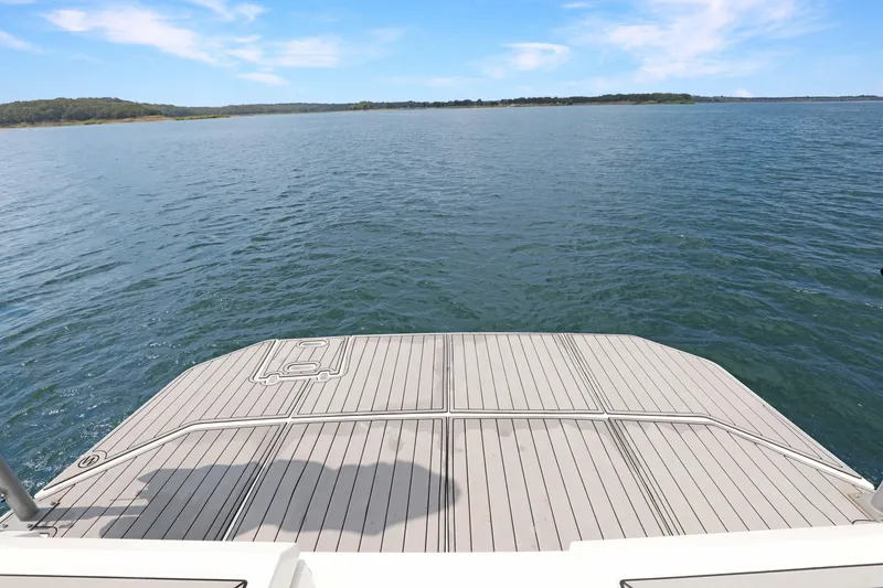 Slide: The Image of 2018 Cruisers Yachts 390 EC swim platform overlooking serene lake and blue sky. - 32