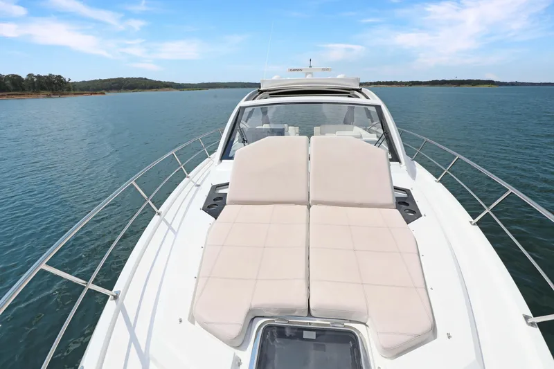 Slide: The Image of 2018 Cruisers Yachts 390 EC on serene water, featuring spacious sunbathing deck. - 35