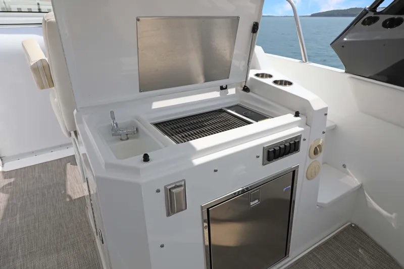 Slide: The Image of 2018 Cruisers Yachts 390 EC outdoor kitchen with sink and grill on deck. - 37