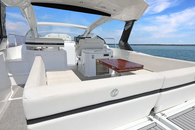 Slide: The Image of 2018 Cruisers Yachts 390 EC interior with seating and table, overlooking the ocean. - 42