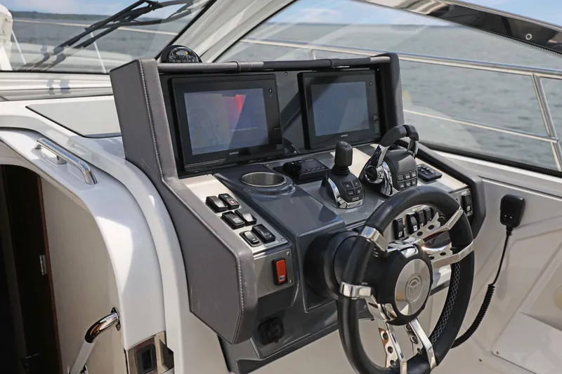 Slide: The Image of 2018 Cruisers Yachts 390 EC helm with dual displays and modern controls. - 50