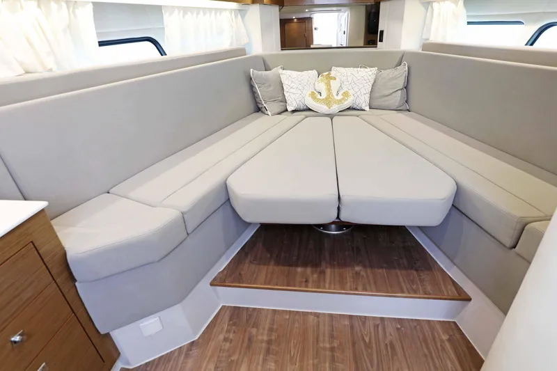 Slide: The Image of Luxurious interior of 2018 Cruisers Yachts 390 EC with elegant seating and nautical decor. - 57