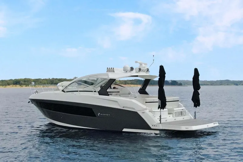 Slide: The Image of 2018 Cruisers Yachts 390 EC on calm water under blue sky. - 7