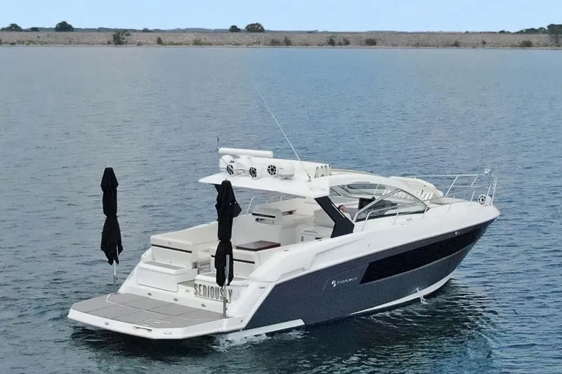 Slide: The Image of 2018 Cruisers Yachts 390 EC on calm water, showcasing sleek design and luxury features. - 8