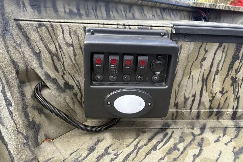 Slide: The Image of Control panel of 2026 SeaArk DXS 1652 DKLD boat with camouflage design. - 11