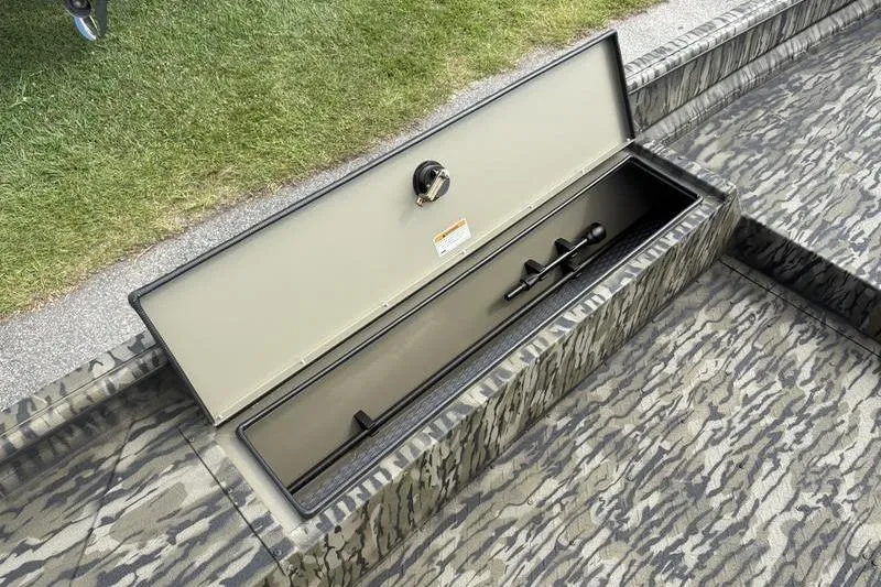 Slide: The Image of Open storage compartment on 2026 SeaArk DXS 1652 DKLD boat, camo pattern. - 13